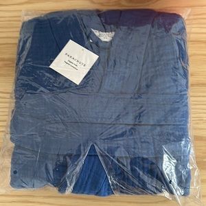 This is a brand new parachute robe with tags. It is a bright blue color.